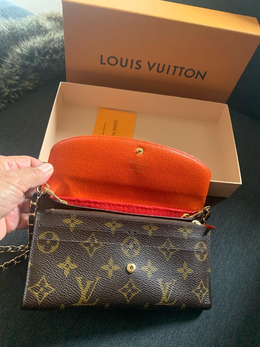Louis Vuitton Monogram Crossbody Wallet in Brown with Orange Interior.